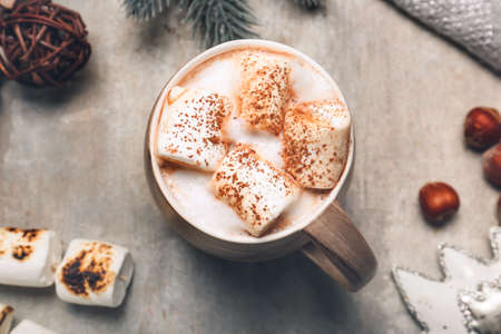 Cup of tasty cocoa drink with marshmallows on tableの写真素材