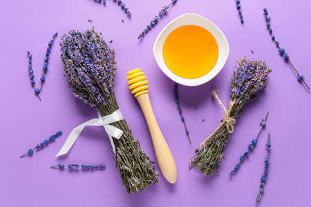 Lavender bouquets with honey on color backgroundの写真素材
