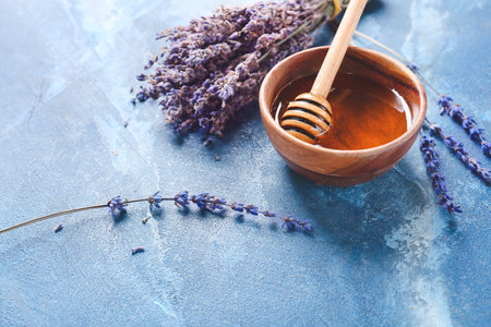 Composition with honey and lavender twigs on tableの写真素材