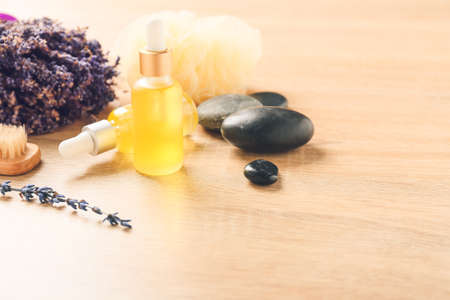 Composition with essential oil bottles and lavender twigs on tableの写真素材