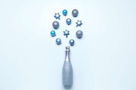 Christmas composition with bottle of champagne on color backgroundの写真素材