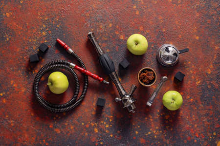 Parts of hookah and apples on grunge background
