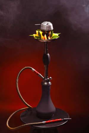 Hookah with orange on dark background