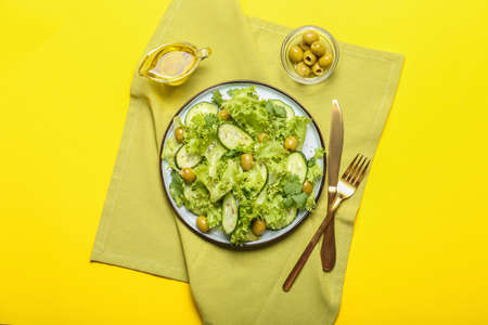 Plate with tasty cucumber salad on color backgroundの写真素材