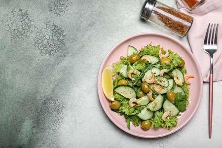 Plate with tasty cucumber salad on color backgroundの写真素材