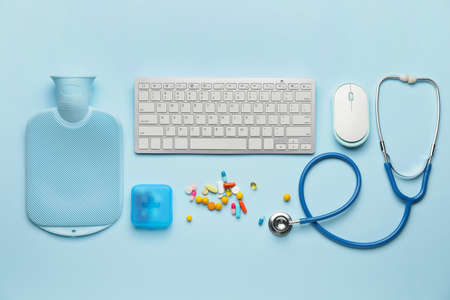 Composition with medical supplies and computer keyboard on color backgroundの写真素材