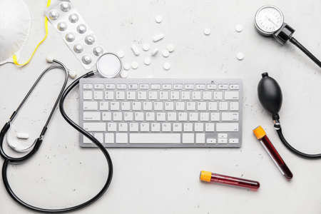 Set of medical supplies with computer keyboard on white backgroundの写真素材
