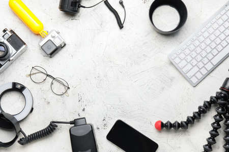 Frame made of modern photographer's equipment and computer keyboard on light background