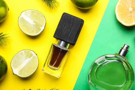 Bottles of citrus perfumes on color backgroundの写真素材