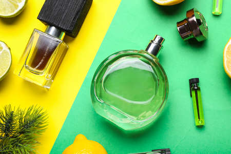 Bottles of citrus perfumes on color backgroundの写真素材