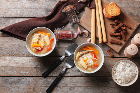 Bowls of tasty rice soup on tableの写真素材