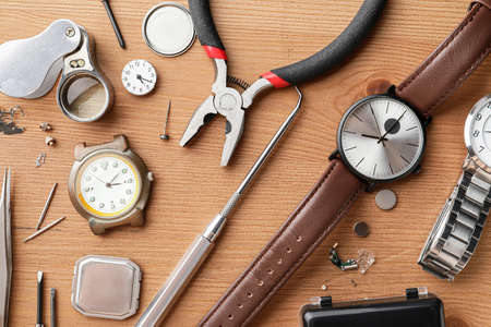 Watches and tools for repair on wooden backgroundの写真素材