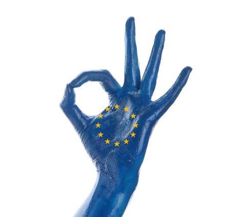Hand painted in colors of European Union flag showing OK gesture on white backgroundの写真素材