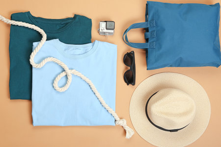 Male beach accessories on color background