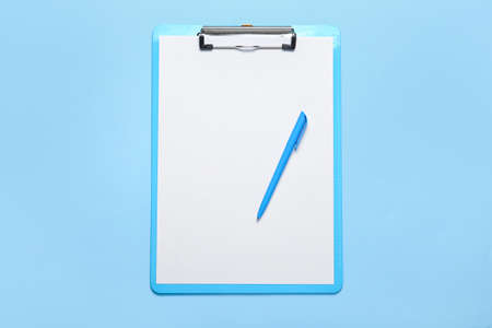 Clipboard with blank paper sheet and pen on color backgroundの写真素材