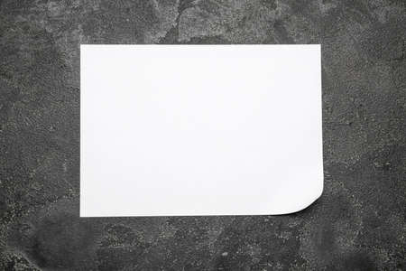 Blank paper sheet on dark backgroundの写真素材