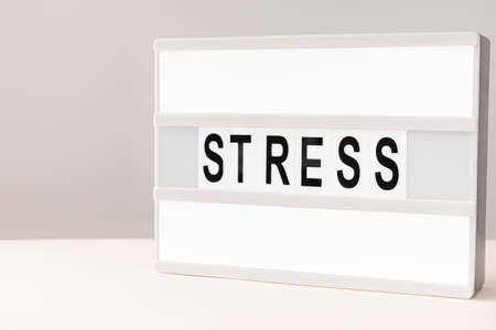 Board with with word STRESS on light backgroundの写真素材