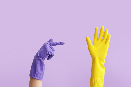 Gesturing hands in rubber gloves on color backgroundの写真素材