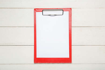 Clipboard with blank paper sheet on wooden backgroundの写真素材