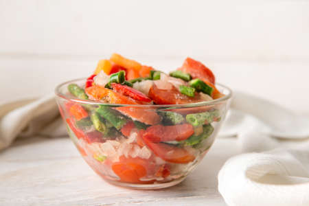 Frozen vegetables in bowl on light backgroundの写真素材