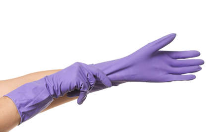 Woman putting on rubber gloves against white backgroundの写真素材