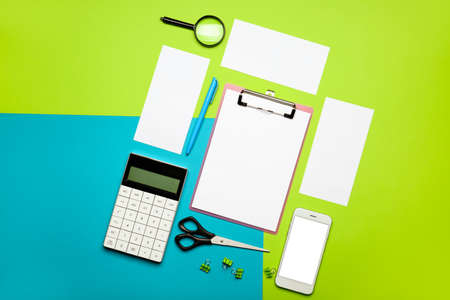 Composition with blank paper sheets and stationary on color backgroundの写真素材