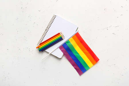 Rainbow LGBT flag, notebook and color pencils on light backgroundの写真素材
