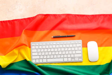 Rainbow LGBT flag, keyboard and mouse on color backgroundの写真素材