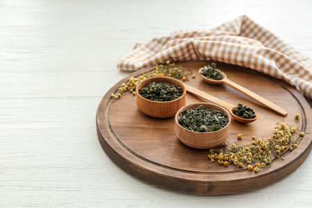 Bowls with dry tea leaves on tableの写真素材