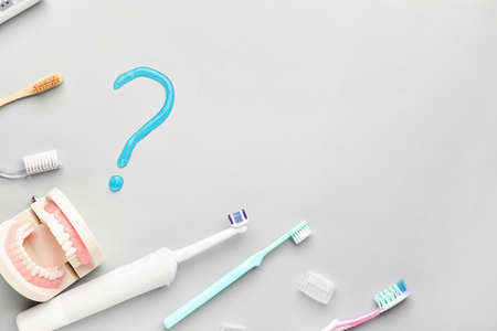 Set of oral hygiene and question mark on light background