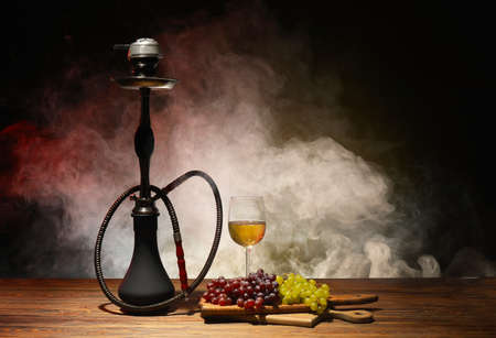 Hookah, glass of wine and grapes on tableの素材 [FY310171405029]