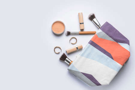 Bag with makeup cosmetics and accessories on white background