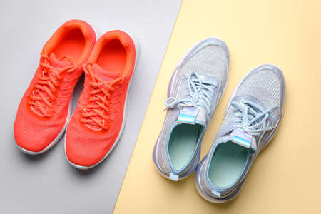 Female sportive shoes on color background