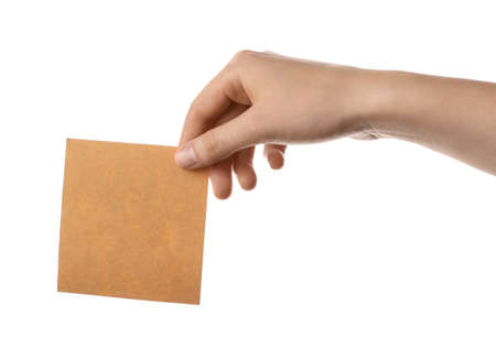 Female hand with blank paper sheet on white backgroundの写真素材