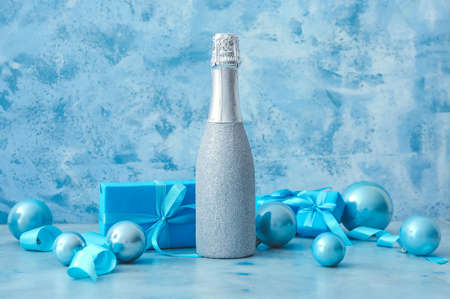 Christmas composition with bottle of champagne on color backgroundの写真素材