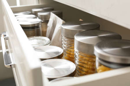 Glass jars with products in drawerの写真素材
