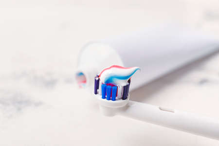 Electric tooth brush with paste on table, closeupの写真素材