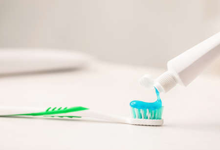 Squeezing of paste on tooth brush, closeup