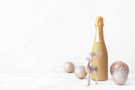 Christmas composition with bottle of champagne on white backgroundの写真素材