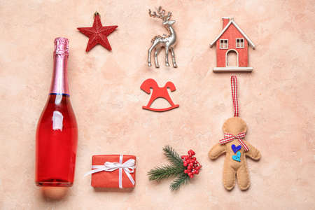 Christmas composition with bottle of champagne on color background