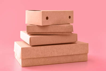 Blank cardboard boxes on color backgroundの写真素材