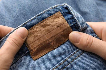 Hands and blank label on clothes
