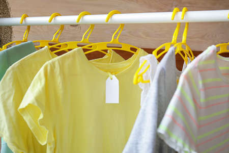 Clothes on hangers with blank paper label
