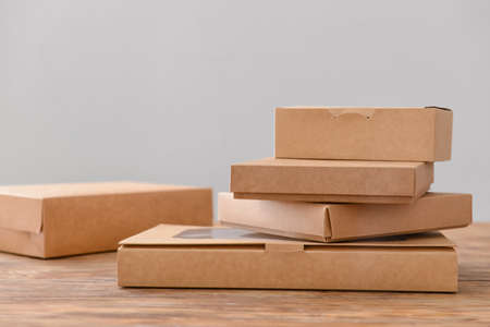 Blank cardboard boxes on wooden tableの写真素材