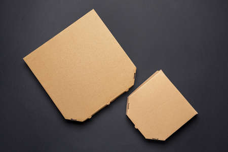 Cardboard pizza boxes on dark backgroundの写真素材