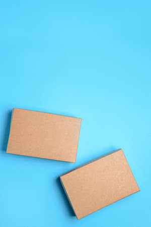 Blank cardboard boxes on color background