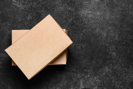 Blank cardboard boxes on dark background