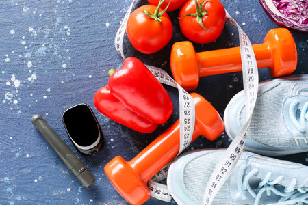 Vegetables, measuring tape, sports equipment, lancet pen and glucometer on color background. Diabetes conceptの写真素材