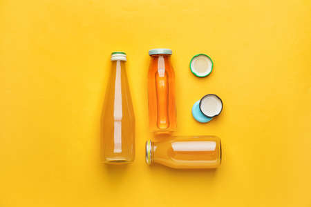 Bottles of juices on color background