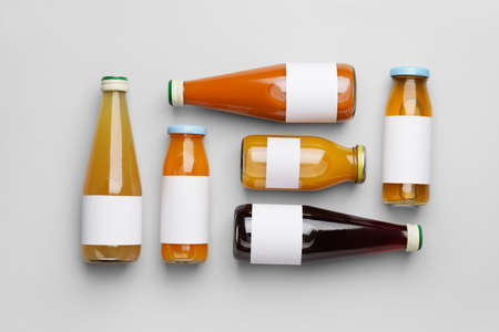 Bottles of juices on light background